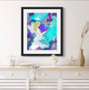 Framed artwork of an angel surrounded by flowers on a white wall above a wooden console table.