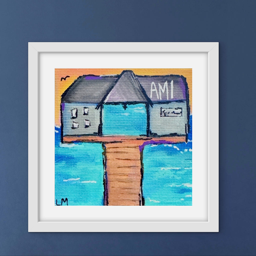 Framed artwork of pier building with 'AM' on a blue background