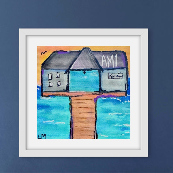 Framed artwork of pier building with 'AM' on a blue background