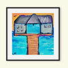 Framed artwork of pier with "AMI" text on building with water scene as background