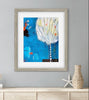 Framed abstract art piece on a wall with decorative items below.