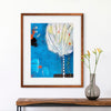 Framed abstract artwork on a wall above a wooden console table with a vase.
