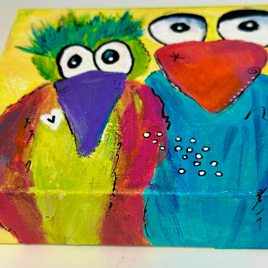 Colorful painting of two birds on a yellow background