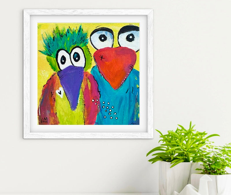 Colorful bird art with a white frame on a light background.