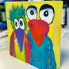 Colorful painting of two whimsical fun loving birds with a yellow background