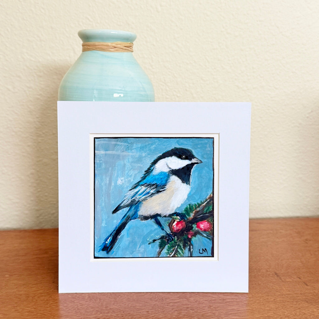 Bird and Berries original acrylic painting by Lori McKinnon, showing a blue, black and white bird beside red berries, displayed in a white mat