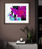 Framed artwork with colorful flowers and the word 'bloom' on a wall in a room.
