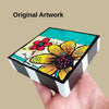 A hand holding a painted wood block with text above it saying 'original artwork'