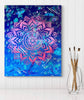 Colorful painting on a white wall with paintbrushes in a glass.