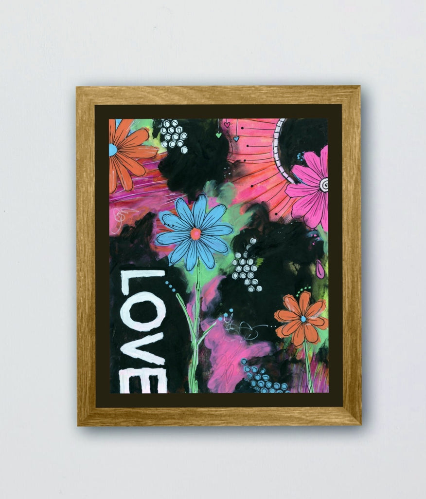 Framed artwork with colorful flowers and the word 'LOVE' on a black background.