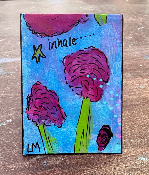 A small painting featuring purple flowers with green stems on a blue background, with the handwritten words 'inhale.