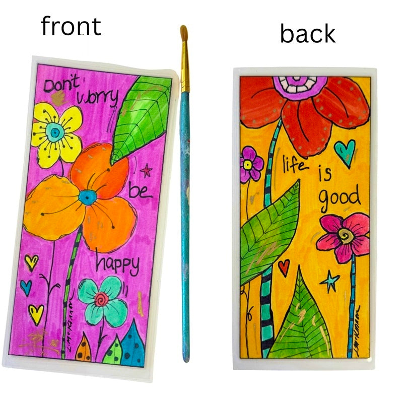 Double sided bookmark with floral designs and motivational phrases, paintbrush for reference