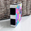 Side view of Cheer Up art block showing its black-and-white striped painted edge and a partial view of the colorful floral artwork
