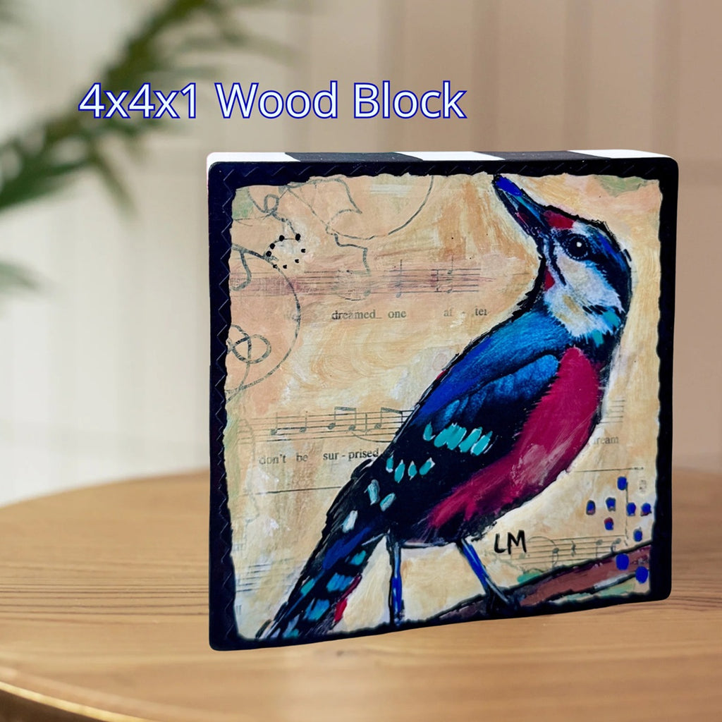 a colorful bird art block standing on a wooden table with text above it '4x4x1 Wood Block'