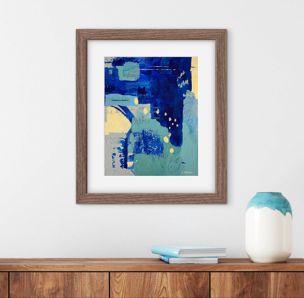 Framed abstract art piece on a wall with a wooden shelf and decorative items.