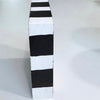 Side view of Coffee wooden art block showing two broad black painted bands on a white edge