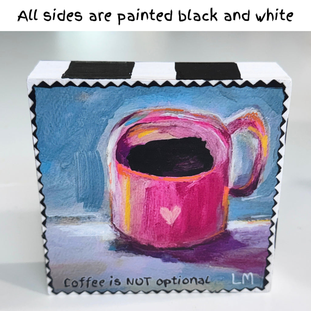 square block with a painting of a cup of coffee with a heart 