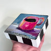 block of wood with artwork of a cup of coffee with a heart on it