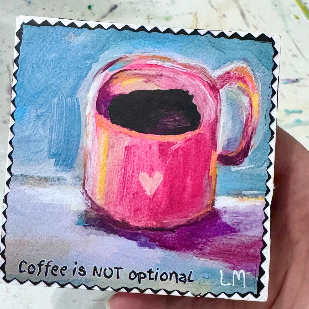 A hand holding a painting of a cup of coffee with text "Coffee is not Optional" and the artist initials 'LM'