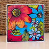 A Colorful Day art block by Lori McKinnon, featuring bold pink, orange, blue, and white flowers with green leaves and black outlines.