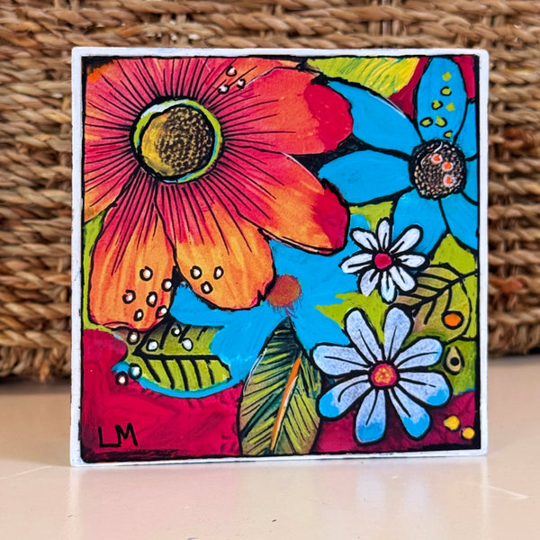 A Colorful Day art block by Lori McKinnon, featuring bold pink, orange, blue, and white flowers with green leaves and black outlines.