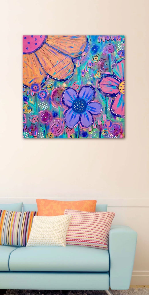 Colorful floral painting on a wall above a light blue sofa with patterned cushions.