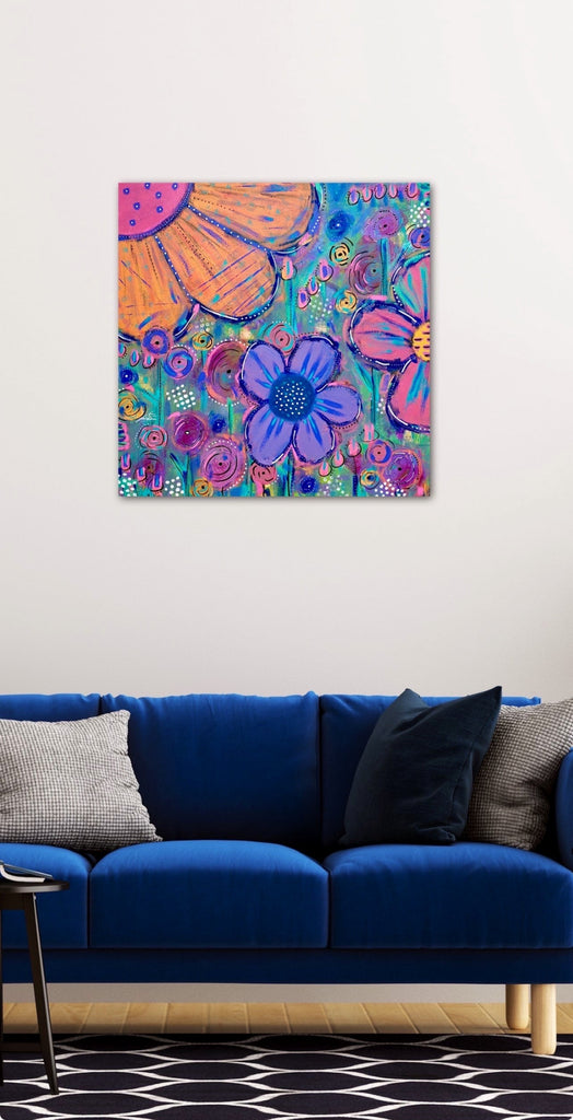 Colorful abstract painting on a wall above a blue sofa with patterned cushions.