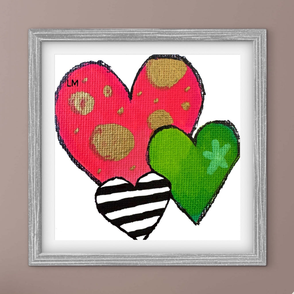 Framed artwork with colorful hearts on a white background