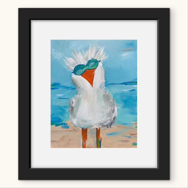 Framed artwork of a bird with sunglasses on a beach