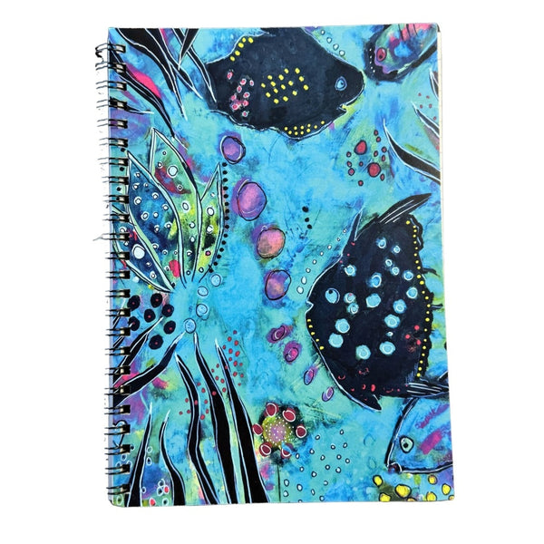 Notebook with colorful fish design on a blue background