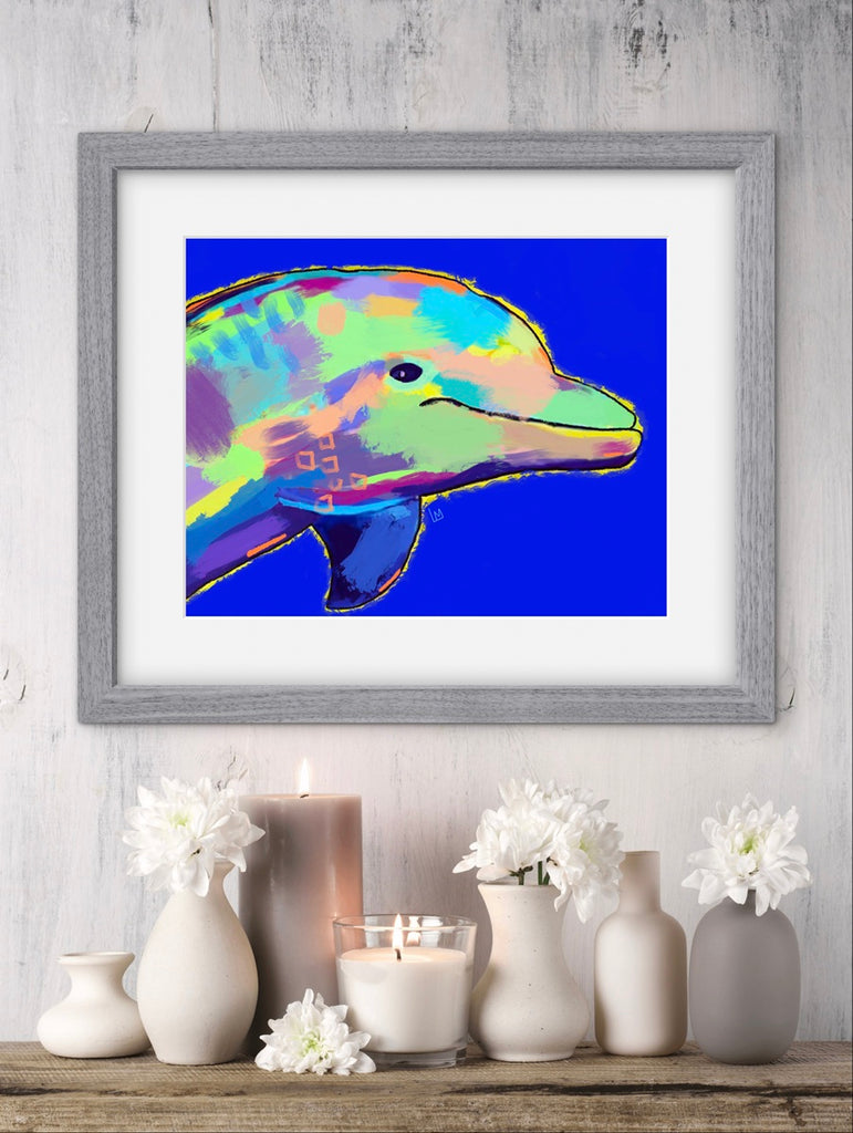 Framed colorful dolphin artwork on a wall above a decorative shelf with candles and vases.