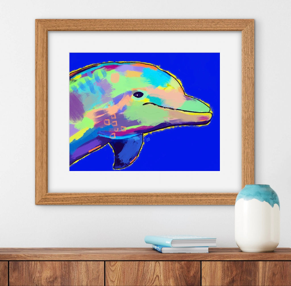 Framed colorful dolphin painting on a wall above a wooden shelf with a vase and books.