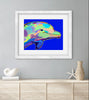 Framed colorful dolphin artwork on a gray wall above a wooden cabinet.