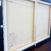 Back of a framed artwork with dimensions and artist information.