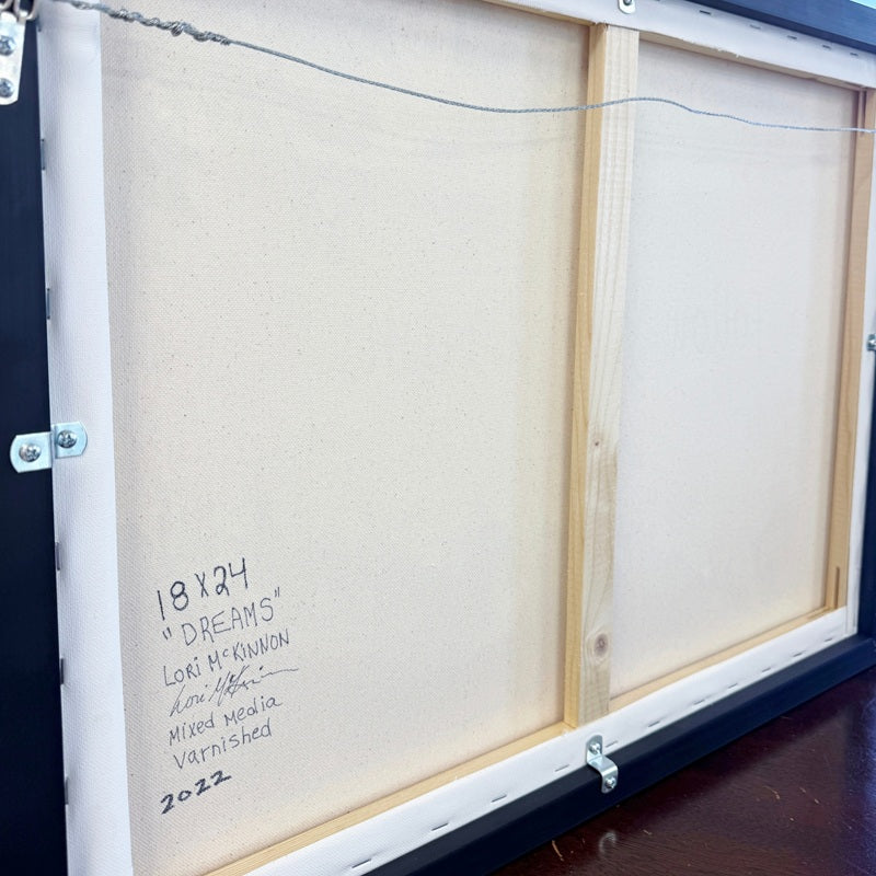 Back of a framed artwork with dimensions and artist information.