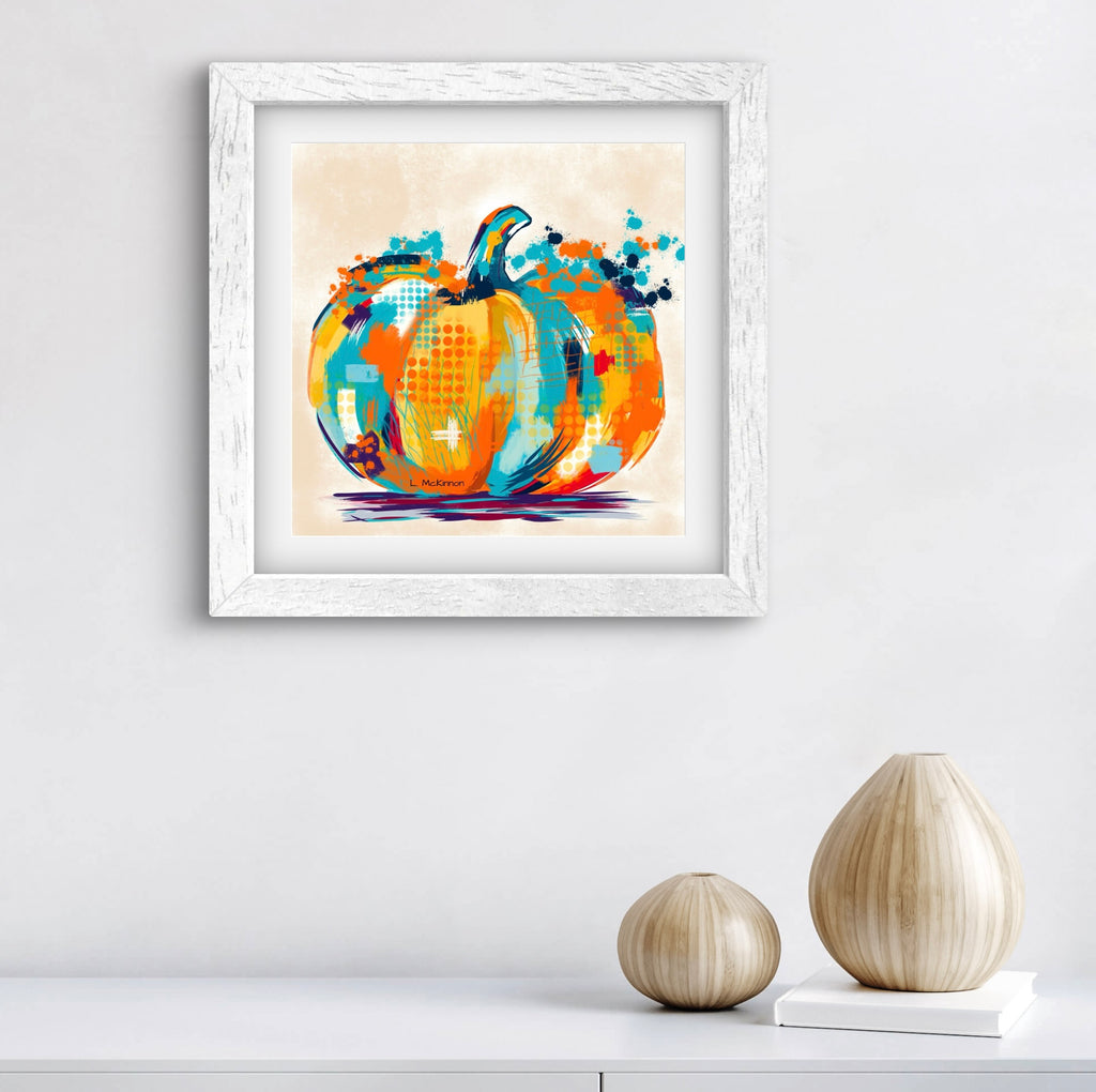 Framed abstract pumpkin art print on a wall with decorative vases below.