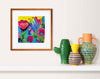 Colorful floral artwork in a brown frame on a white wall above a shelf with some vases on it