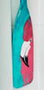 Painted oar paddle with a flamingo design on a white background
