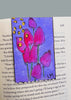 painted floral bookmark displayed on a book page