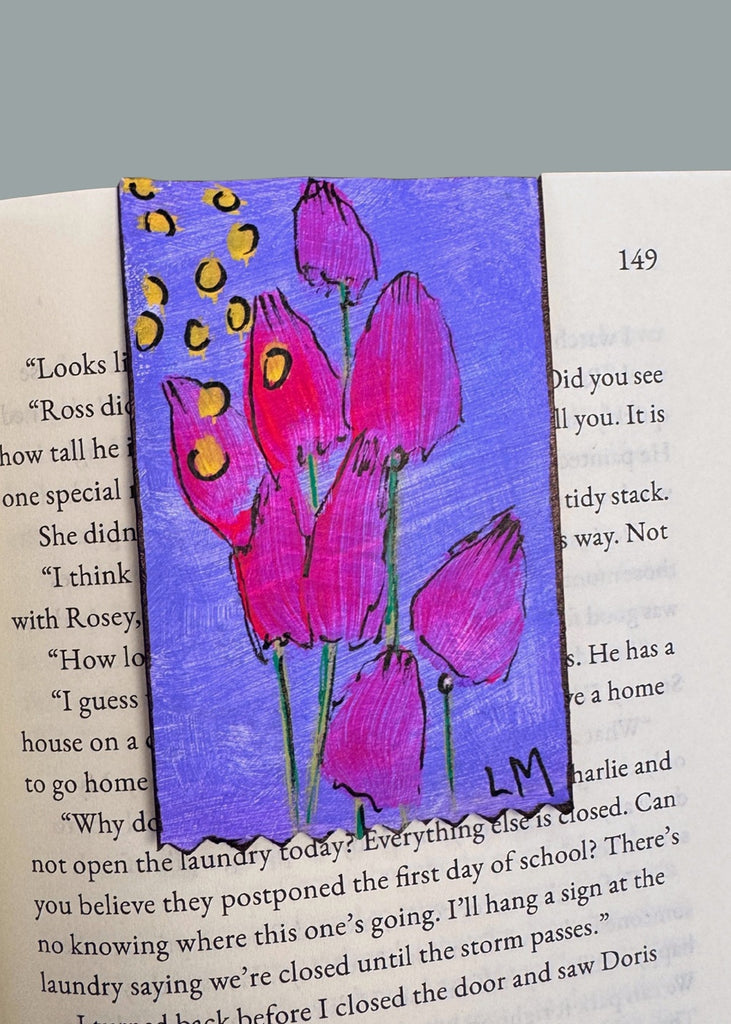 painted floral bookmark displayed on a book page