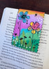 floral painted bookmark displayed on a book page