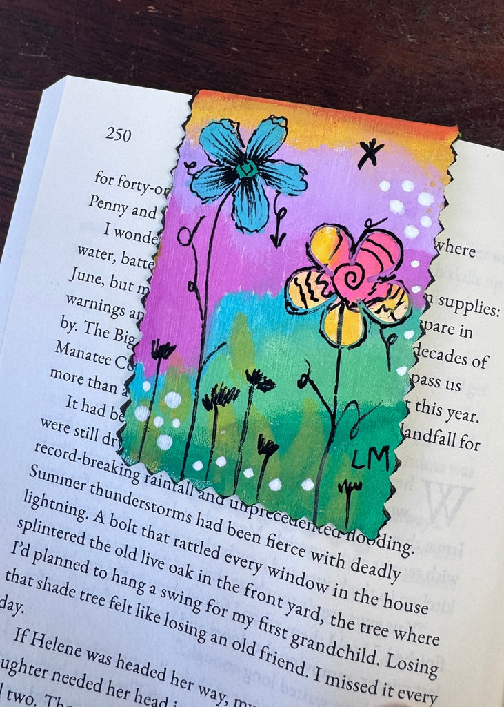 floral painted bookmark displayed on a book page