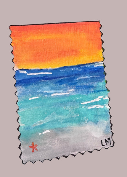 small beach painting on a gray surface
