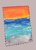 small beach painting on a gray surface