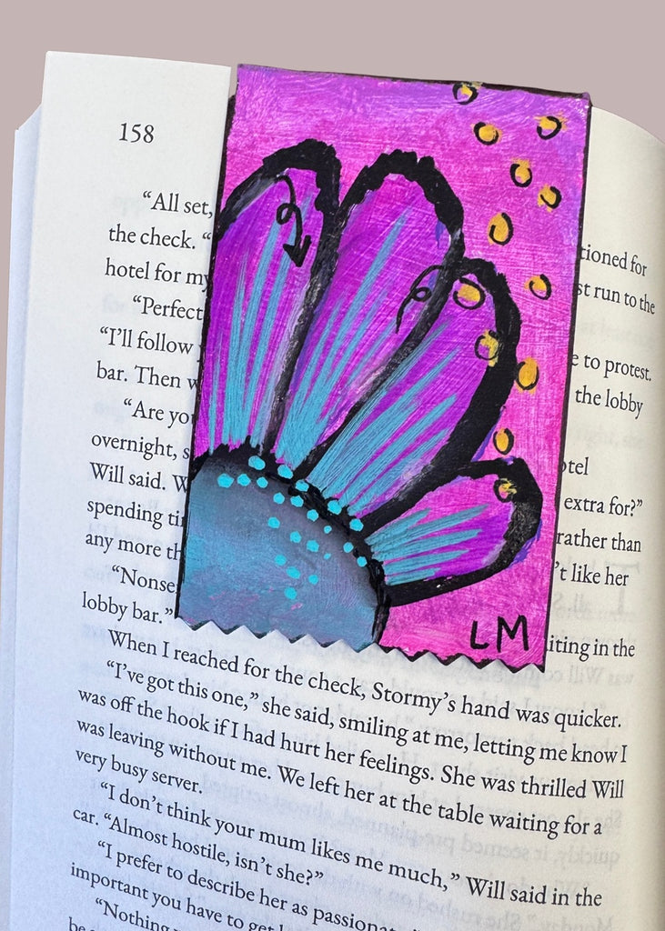 a floral bookmark on a book page