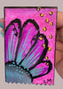 floral painting held by a hand