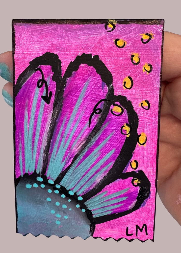 floral painting held by a hand