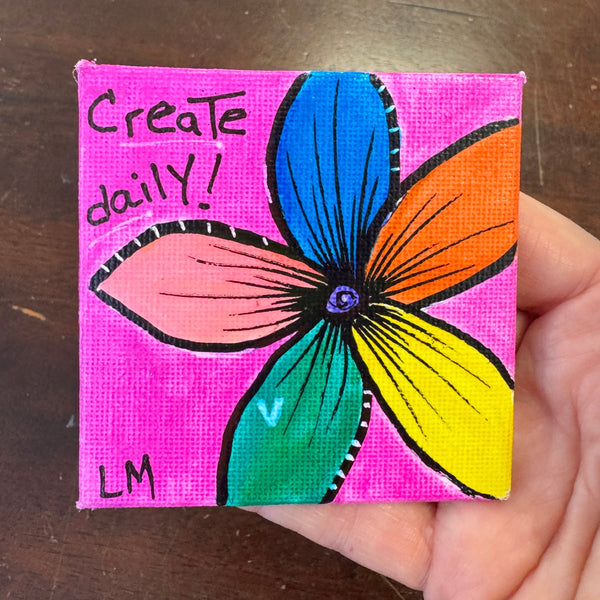 colorful flower magnet with pink background says create daily