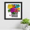 Framed artwork with colorful flowers and a striped vase on a white wall.