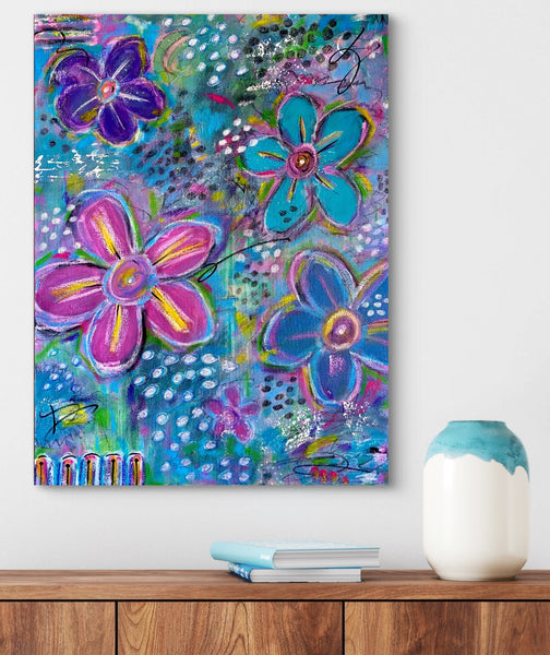 Colorful floral painting on a wall above a wooden shelf with a vase and books.